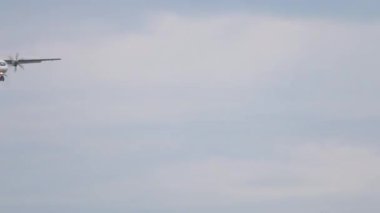 NOVOSIBIRSK, RUSSIAN FEDERATION - JULY 15, 2022: ATR-72 of UTair descent for landing. Long shot of a turboprop passenger plane approaching at Tolmachevo airport