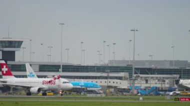 AMSTERDAM, THE NETHERLANDS - JULY 27, 2017: Airbus 319 of SWISS taxiing on the runway before departure at Shiphol Airport, Amsterdam, Holland. Tourism and travel concept. Aviation Spotting