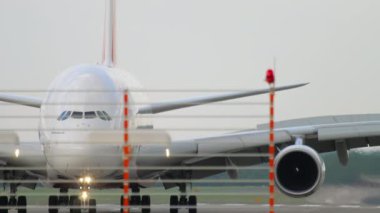 DUSSELDORF, GERMANY - JULY 23, 2017: Airbus A380 of Emirates taxiing after landing to the terminal at Dusseldorf airport