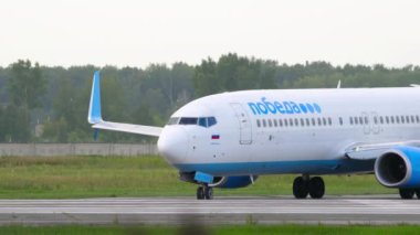 NOVOSIBIRSK, RUSSIAN FEDERATION - JULY 15, 2022: Boeing 737 of Pobeda Airlines taxiing on the runway at Tolmachevo airport. Tourism and travel concept