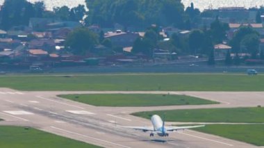 SOCHI, RUSSIA - JULY 28, 2022: Long shot rear view of Boeing 737 Pobeda airline takeoff and climb over the sea at Sochi International Airport. Tourism and travel concept