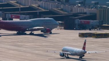 SOCHI, RUSSIA - JULY 28, 2022: Widebody Boeing 747 of Rossiya taxis to the terminal after landing at Sochi airport. Tourism and travel concept. Aviation traffic. Airbus Nordwind on the airfield