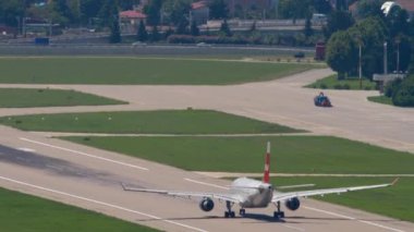 SOCHI, RUSSIA - JULY 28, 2022: Cinematic shot of Airbus A330 Nordwind taking off at Sochi International Airport. Airliner departure, slow motion. Tourism and travel concept