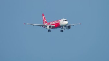 PHUKET, THAILAND - DECEMBER 02, 2018: Airbus A320 of AirAsia approaching before landing at Phuket airport HKT. Traffic at Phuket Airport