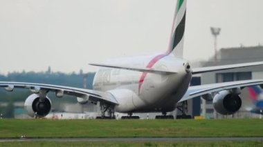 DUSSELDORF, GERMANY - JULY 23, 2017: Airbus A380 of Emirates Airlines taxiing at Dusseldorf airport, rear view. Widebody double-deck four-engine turbojet passenger aircraft. Tourism and travel concept