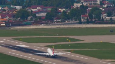 SOCHI, RUSSIA - JULY 31, 2022: Long shot Airplane of Nordwind taking off at Sochi International Airport. Airliner departure, slow motion. Tourism and travel concept