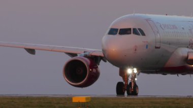 KAZAN, RUSSIA - AUGUST 05, 2022: Airbus A320 Rossiya Airlines taxiing at sunset in Kazan airport, close-up shot. Commercial passenger aircraft on the runway. Flight arrives or departs