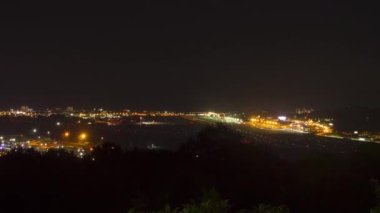 Airport airfield at night, time lapse. Airplane takeoffs and landings, traffic. Panoramic view of the airport and the city. Tourism and travel concept