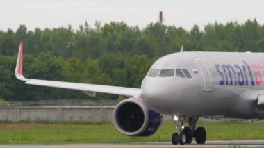 NOVOSIBIRSK, RUSSIAN FEDERATION - JULY 15, 2022: Airbus A320neo of Smartavia rides on the taxiway at Tolmachevo Airport, Novosibirsk. Airplane taxiing on runway
