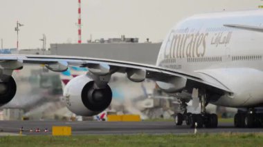 DUSSELDORF, GERMANY - JULY 23, 2017: Double-deck Airbus A380 of Emirates Airlines taxiing at Dusseldorf airport. Widebody jet passenger aircraft. Cinematic shot of an airplane on the runway