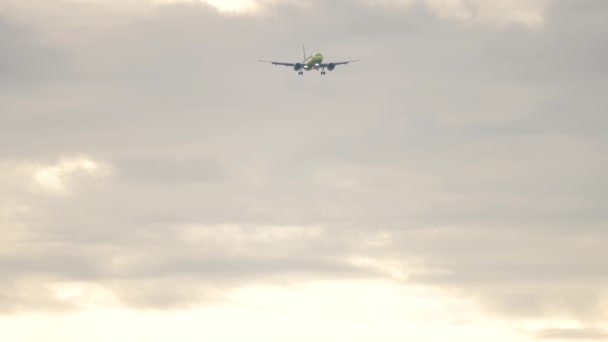 长长的喷气式客机在多云的天空中接近着陆 慢动作 客机在飞行 旅游和旅行概念 — 图库视频影像