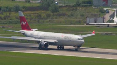 SOCHI, RUSSIA - JULY 29, 2022: Airbus A330 of Nordwind arrived at Sochi International Airport. Braking after landing, flaps up. Tourism and travel concept