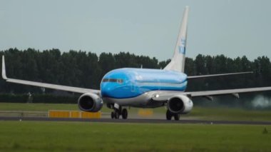 AMSTERDAM, THE NETHERLANDS - JULY 24, 2017: Commercial aircraft Boeing 737 of KLM taking off at Schiphol Airport, Amsterdam. Tourism and travel concept