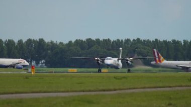 AMSTERDAM, THE NETHERLANDS - JULY 24, 2017: Turboprop aircraft FlyBe takeoff and climb at Schiphol Airport, Amsterdam. Tourism and travel concept