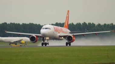 AMSTERDAM, THE NETHERLANDS - JULY 26, 2017: Airbus A320 of EasyJet picking up speed and takeoff at Schiphol Airport, Amsterdam. Tourism and travel concept