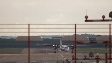 DUSSELDORF, GERMANY - JULY 23, 2017: De-Havilland-Canada DHC-8-400 of Air Baltic taxis after landing at the airport terminal in Dusseldorf, Germany. National airline of Latvia