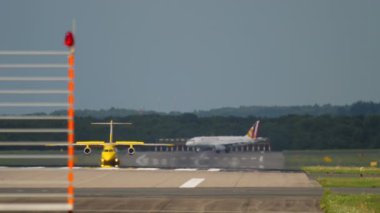 DUSSELDORF, GERMANY - JULY 23, 2017: Dornier 328 jet of Aero-Dienst Ambulance braking after landing and taxiing at Dusseldorf International airport DUS. Germanwings taxiing into the background