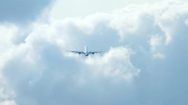 Airplane silhouette departure and climb. Jet plane flies away, long shot rear view. Tourism and travel concept