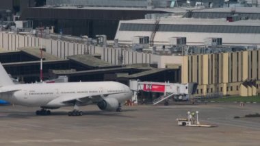 SOCHI, RUSSIA - JULY 30, 2022: Boeing 777, RA-73340 of Nordwind Airlines taxiing to the terminal after landing at Sochi airport. Airplane arrival at the airport and taxiing to the gangway