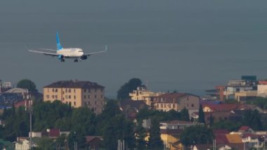SOCHI, RUSSIA - JULY 30, 2022: Commercial aircraft Boeing 737 of Pobeda Airlines landing at Sochi airport, long shot. Tourism and travel concept