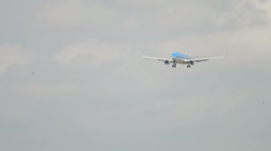 AMSTERDAM, THE NETHERLANDS - JULY 27, 2017: Passenger jet aircraft Boeing 737 of KLM approaching to land at Schiphol Airport, Amsterdam. Long shot front view civil aircraft in the sky
