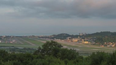 Timelapse of an airport, traffic. Clouds float beautifully over the city. Panoramic view of the runway