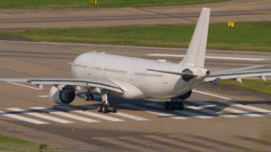 Passenger plane on the runway, ready to take off. Rear view, civil jet airliner on the airfield. Tourism and travel concept