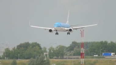 AMSTERDAM, THE NETHERLANDS - JULY 27, 2017: Passenger jet aircraft Boeing 737 of KLM landing and braking at Schiphol Airport, Amsterdam. Civil aircraft arrival