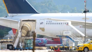 PHUKET, THAILAND - DECEMBER 02, 2018: Boeing 777 of Nordwind Airlines at Phuket airport terminal. Aircraft service before departure