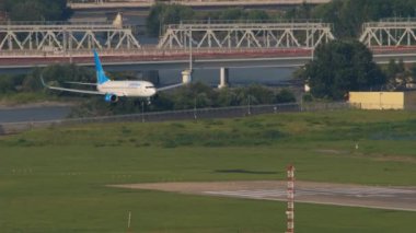 SOCHI, RUSSIA - JULY 30, 2022: Passenger aircraft Boeing 737 of Pobeda Airlines landing, touchdown and braking at Sochi airport, long shot. Tourism and travel concept