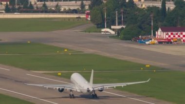 Passenger jet lifts the landing gear off the runway and climbs. Airplane takeoff, airfield. Tourism and travel concept