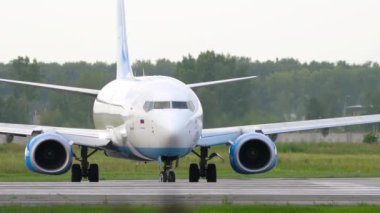 NOVOSIBIRSK, RUSSIAN FEDERATION - JULY 15, 2022: Boeing 737, RA-73229 of Pobeda Airlines riding from taxiway to runway at Tolmachevo airport. Low-cost airliner taxiing. Tourism and travel concept
