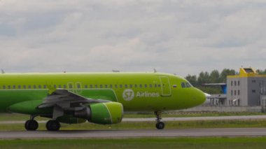 NOVOSIBIRSK, RUSSIAN FEDERATION - JULY 15, 2022: Airplane of S7 Airlines accelerating on the runway before takeoff at Tolmachevo airport, side view. Tourism and aviation concept