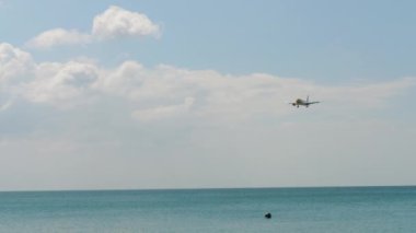 PHUKET, THAILAND - NOVEMBER 29, 2019: Airbus A320 of Scoot landing at Phuket airport HKT. Tourism and travel concept