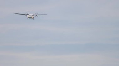 Long shot of a turboprop passenger plane approaching before landing at Tolmachevo airport. Tourism and travel concept
