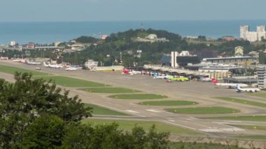 SOCHI, RUSSIA - JULY 29, 2022: Time lapse view of the airport. Daytime traffic at a busy airport. Runway and terminal. Tourism and travel concept