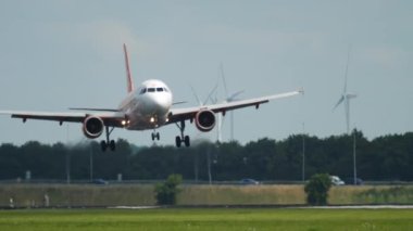 AMSTERDAM, THE NETHERLANDS - JULY 26, 2017: Airbus A320 of EasyJet arrival at Schiphol Airport, Amsterdam. Tourism and travel concept