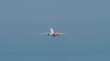 SOCHI, RUSSIA - JULY 31, 2022: Boeing 737 Izhavia climb, rear view long shot. Tourism and travel concept. Airliner flies away