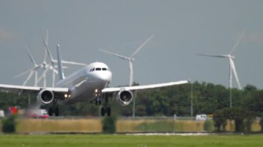 AMSTERDAM, THE NETHERLANDS - JULY 26, 2017: Passenger jet plane of AirFrance landing on a sunny day, medium shot. Tourism and travel concept