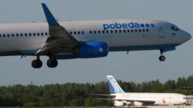 NOVOSIBIRSK, RUSSIAN FEDERATION - JUNY 12, 2022: Boeing 737, RA-73249 Pobeda Airlines landing at Tolmachevo Airport, Novosibirsk. Tourism and travel concept, air flight.