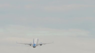 NOVOSIBIRSK, RUSSIAN FEDERATION - JULY 15, 2022: Boeing 737 of Pobeda Air takeoff and climb, rear view. Tourism and travel concept