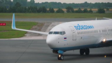 NOVOSIBIRSK, RUSSIAN FEDERATION - JULY 24, 2021: Boeing 737 of Pobeda Airlines taxiing at Tolmachevo airport. Tourism and travel concept, air flight. Russian low cost airline