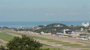 SOCHI, RUSSIA - JULY 29, 2022: Timelapse of airport traffic. Panoramic view of the airfield and aircraft