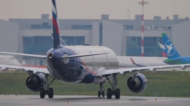 MOSCOW, RUSSIAN FEDERATION - JULY 28, 2021: Aeroflot plane rides on the taxiway, rear view. Commercial plane Russian Airlines at Sheremetyevo airport. Tourism and aviation concept