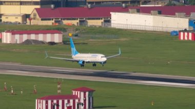 SOCHI, RUSSIA - JULY 30, 2022: Boeing 737 of Pobeda Airlines landing and braking at Sochi airport, long shot. Tourism and travel concept
