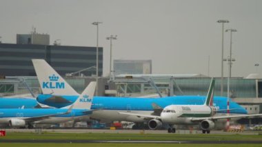 AMSTERDAM, THE NETHERLANDS - JULY 27, 2017: Alitalia taxiing on the airfield of Amsterdam airport. KLM Airlines aircraft in the background. Travel concept