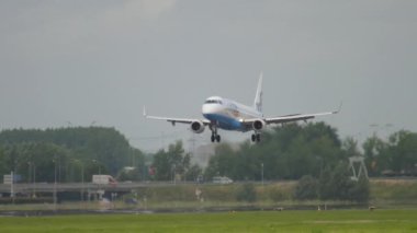 AMSTERDAM, THE NETHERLANDS - JULY 27, 2017: Airplane of Flybe landing at Schiphol airport, super slow motion. Tourism and travel concept