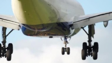 Cinematic footage of jet plane landing. Runway brightly lit with landing lights. Tourism and travel concept