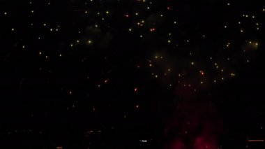 Festive fireworks in the night sky over the city. Holiday concept. Bright lights in honor of the holiday. New Years and Christmas