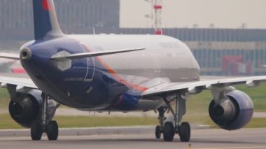 MOSCOW, RUSSIAN FEDERATION - JULY 28, 2021: Airbus A320 of Aeroflot taxiing at Sheremetyevo airport, side view. Civil aircraft on the taxiway. Tourism and travel concept